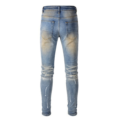 Men's Blue Jeans with Black Patches, Distressed Paint, and Ripped Details